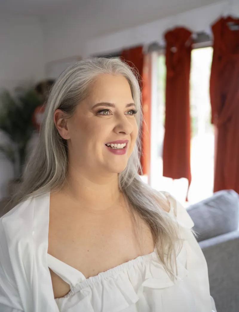 Smiling glam makeup with grey hair